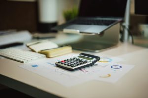 Calculator on a desk with documents.