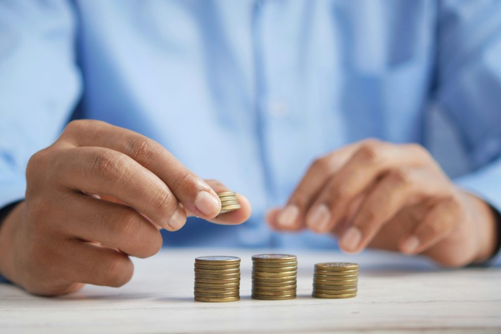 Strategic vs Financial Buyer: Which Is Better for Your Exit 3 Hands stacking coins on table